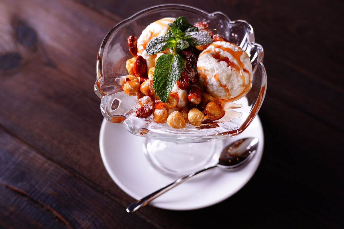 Ice cream sundae with dulce de leche and roasted nuts